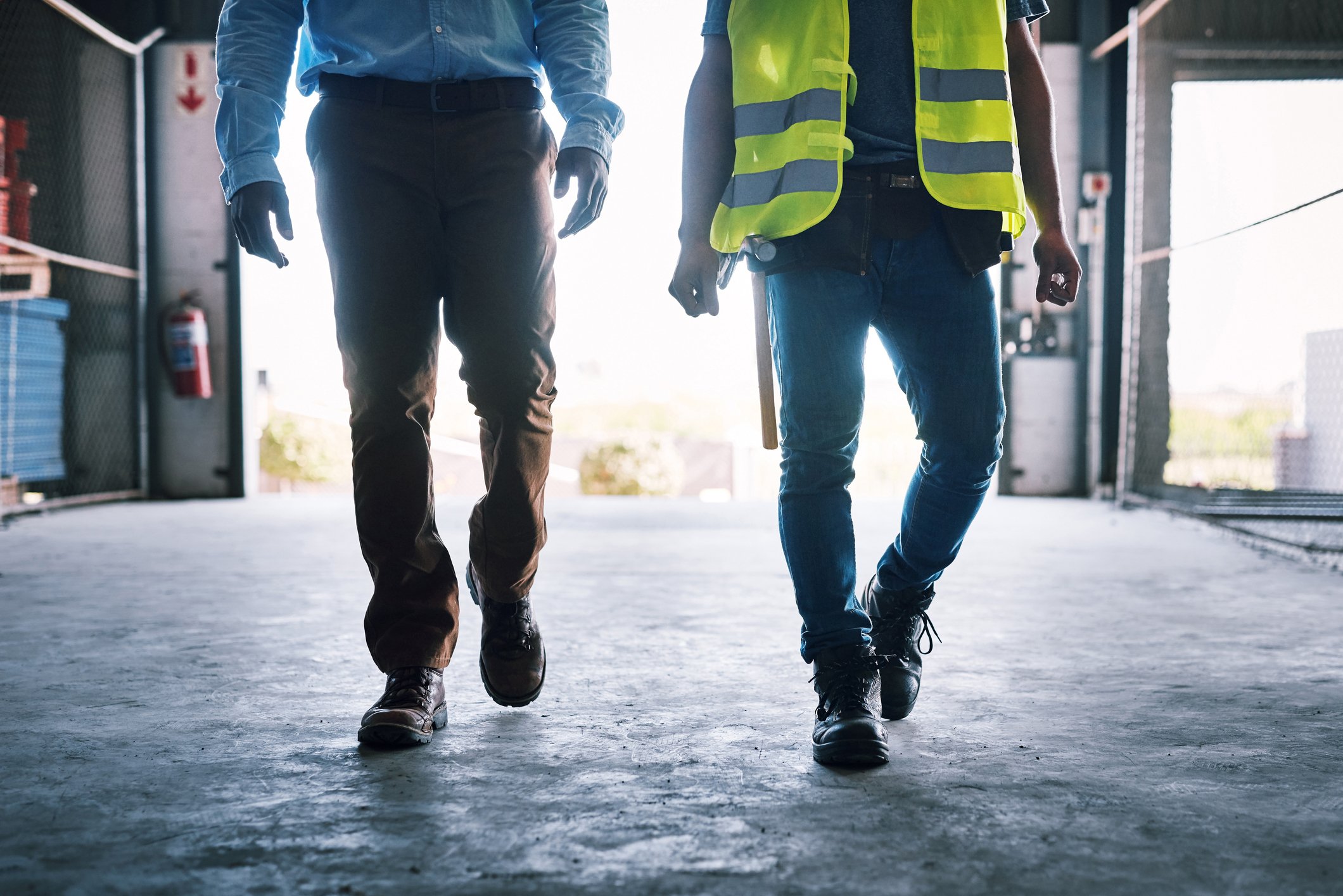 Shot of two unrecognisable builders walking through a construction site