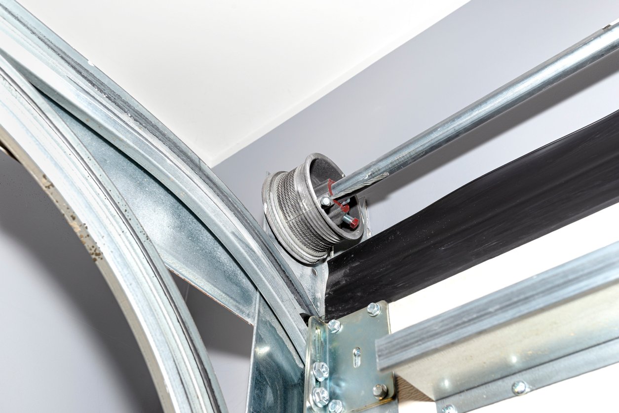 garage door guide tracks with visible cable drum and steel rope systems for reliable loading dock access