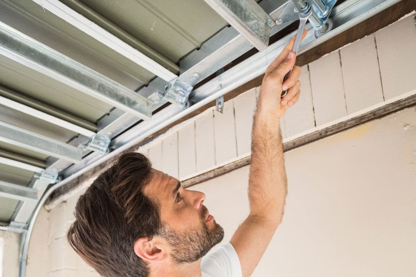 professional performing loading dock garage door opener repair—expert maintenance ensuring reliable industrial access systems