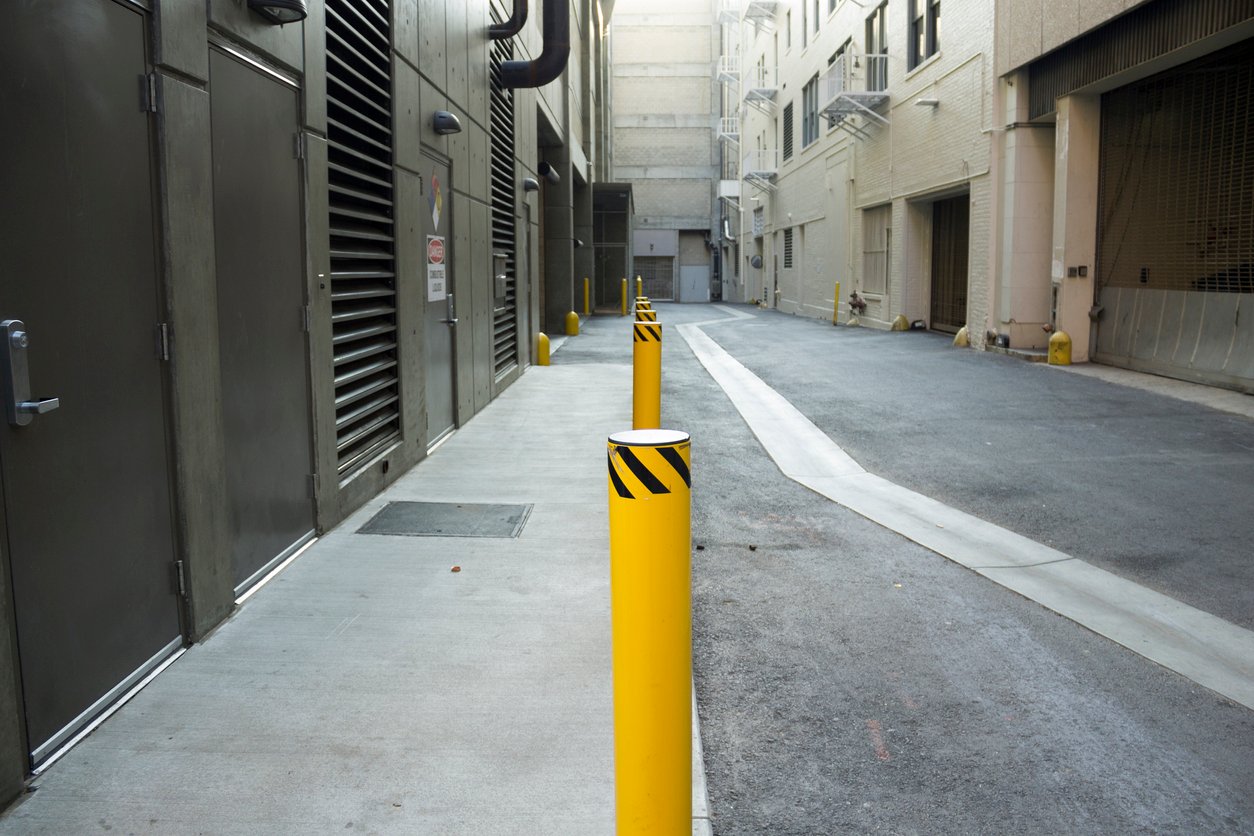 A shot of yellow poles in an alley in downtown Los Angeles.