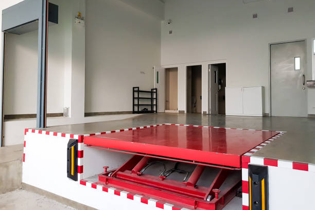 Industrial loading dock with red hydraulic lift platform for goods handling